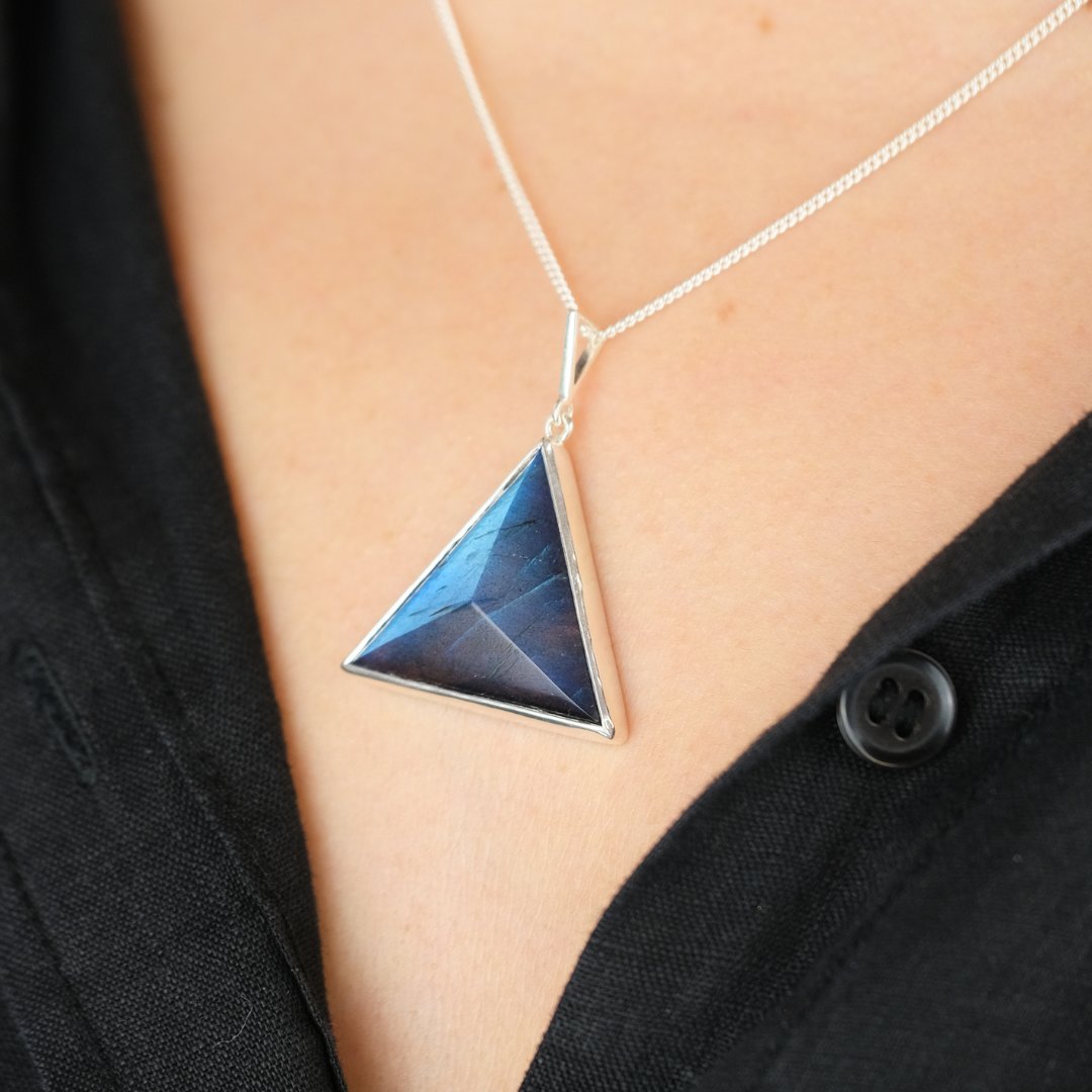 A model wearing a triangle labradorite crystal necklace