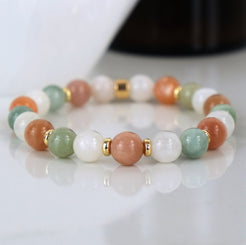 A moonstone, sunstone and jade gemstone bracelet with 18ct gold plated accessories