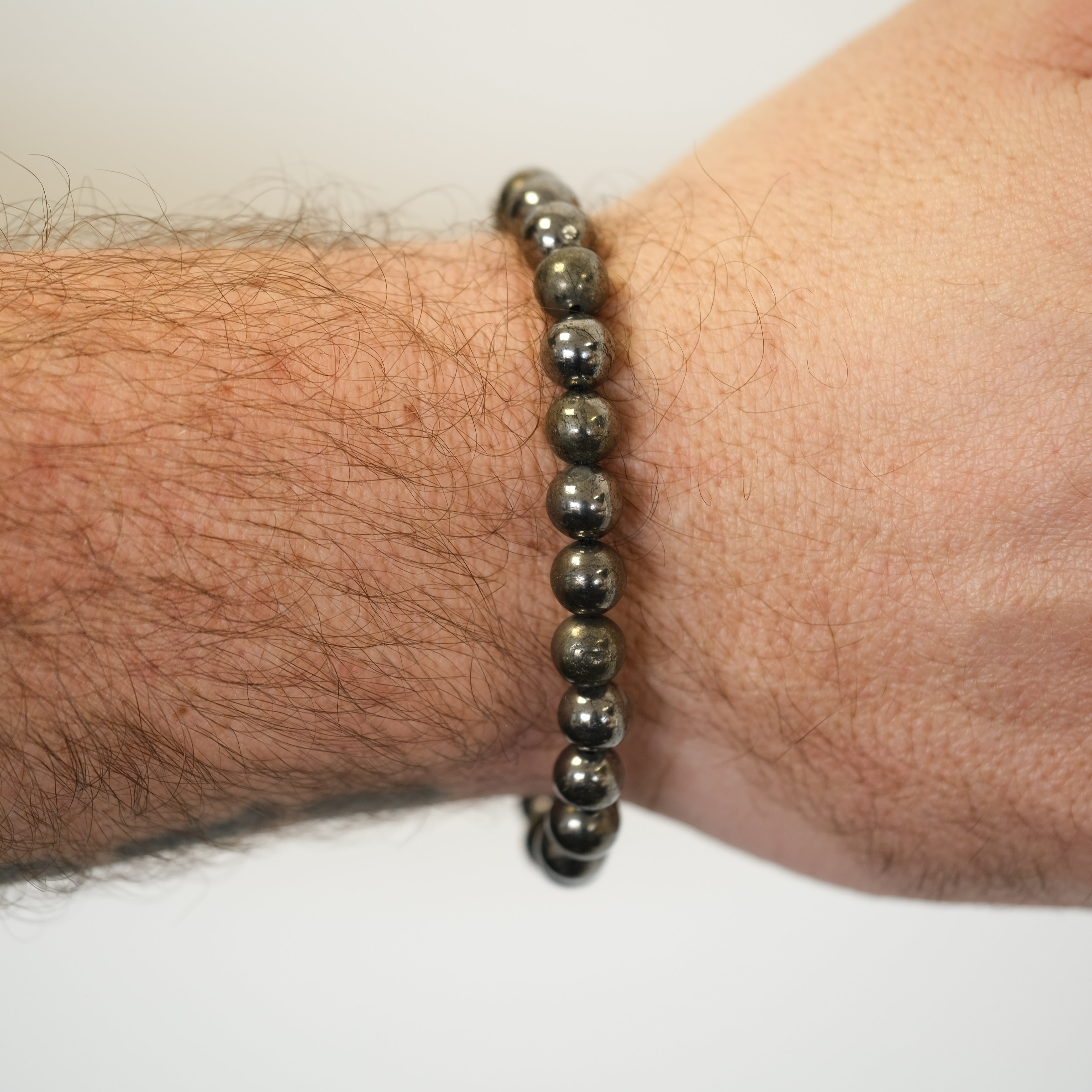 A pyrite bracelet worn on a model's wrist