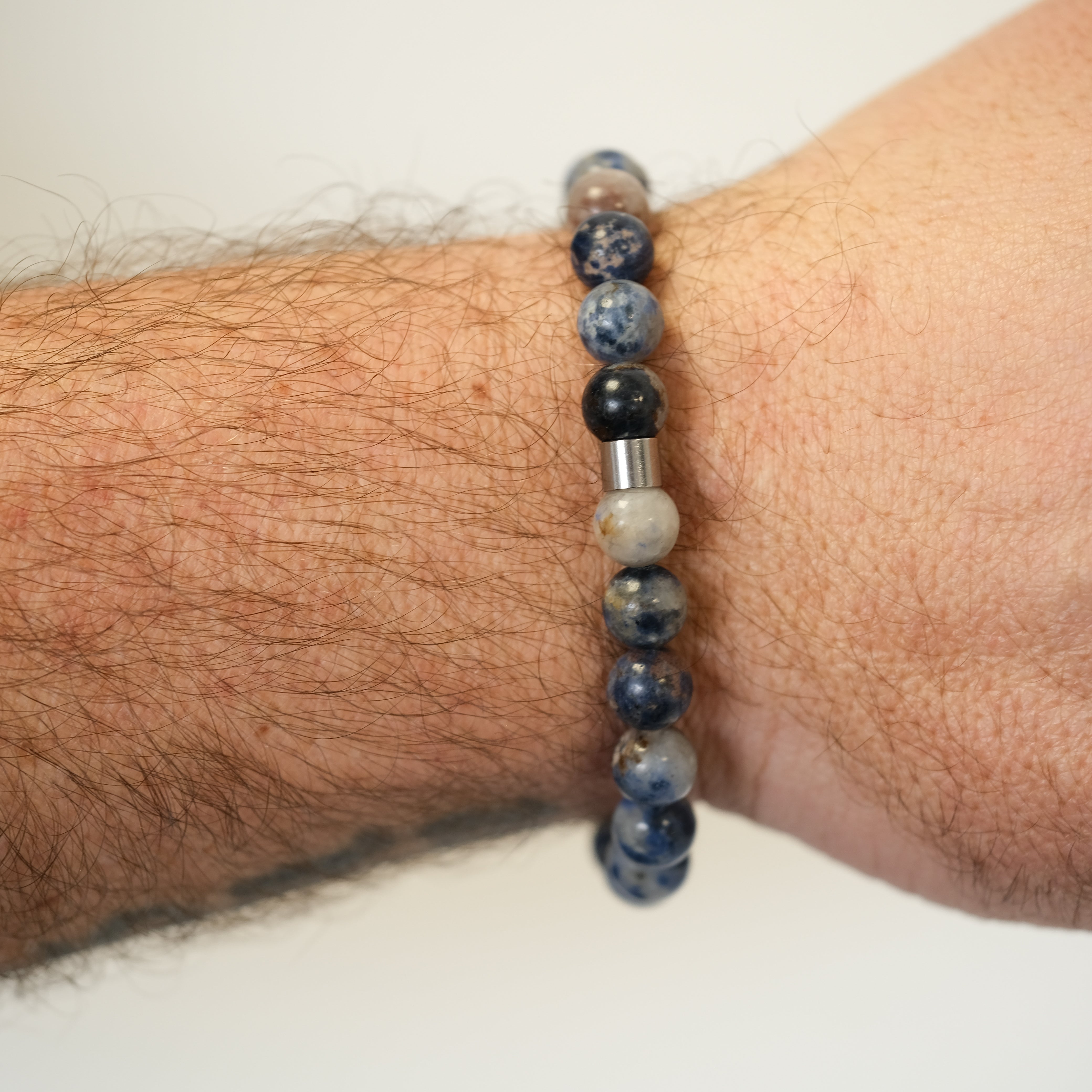 Pegmatite gemstone bracelet worn on a model's wrist from behind