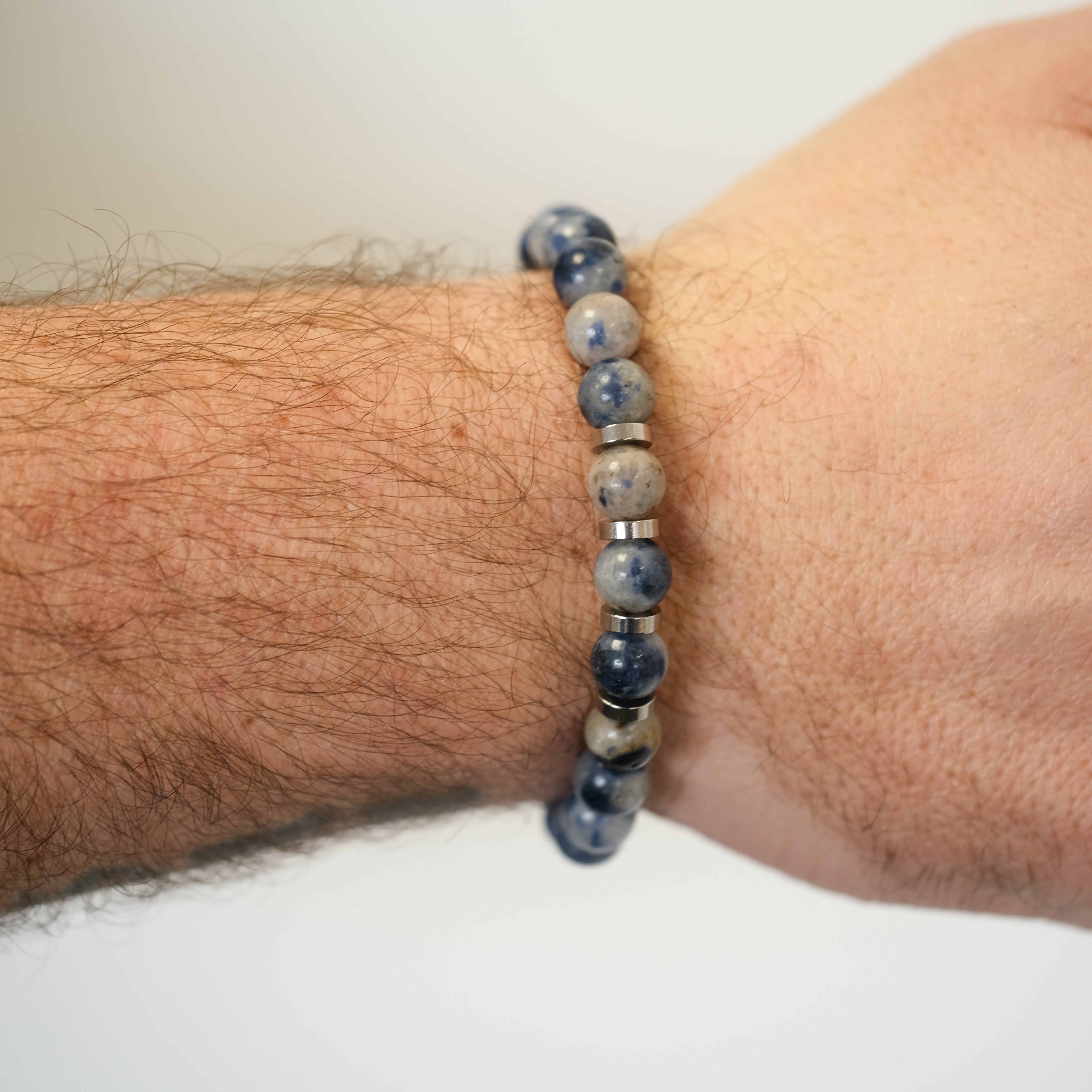 Pegmatite gemstone bracelet worn on a model's wrist