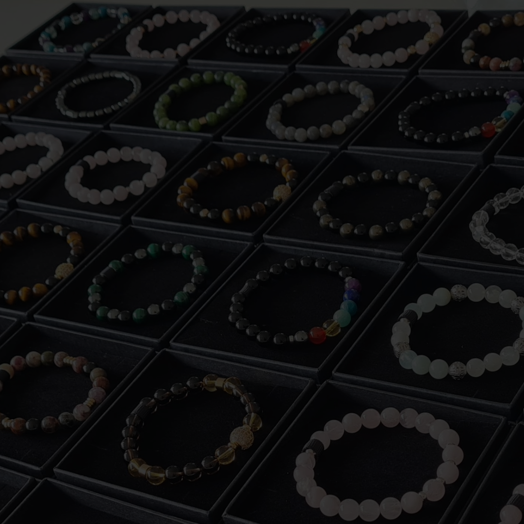 Rows of gemstone bracelets in boxes