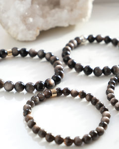 A Tiger Eye crystal bracelet with a stainless steel accessory