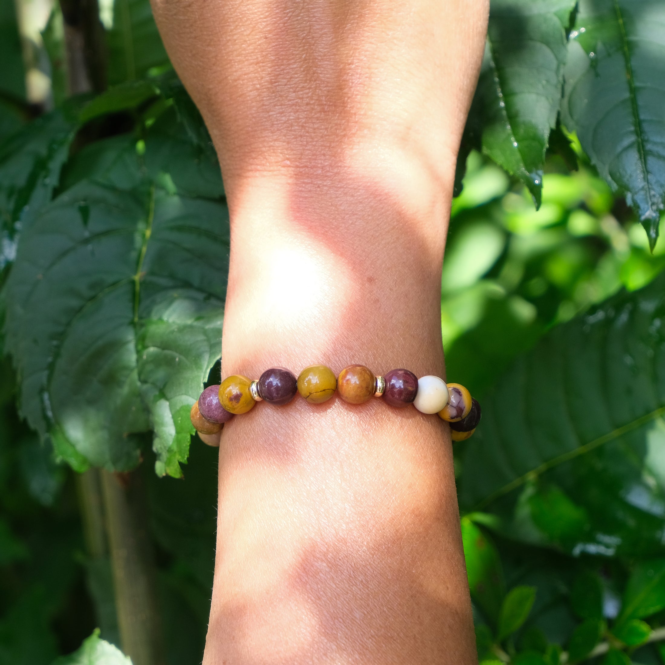 A model wearing a mookaite gemstone bracelet