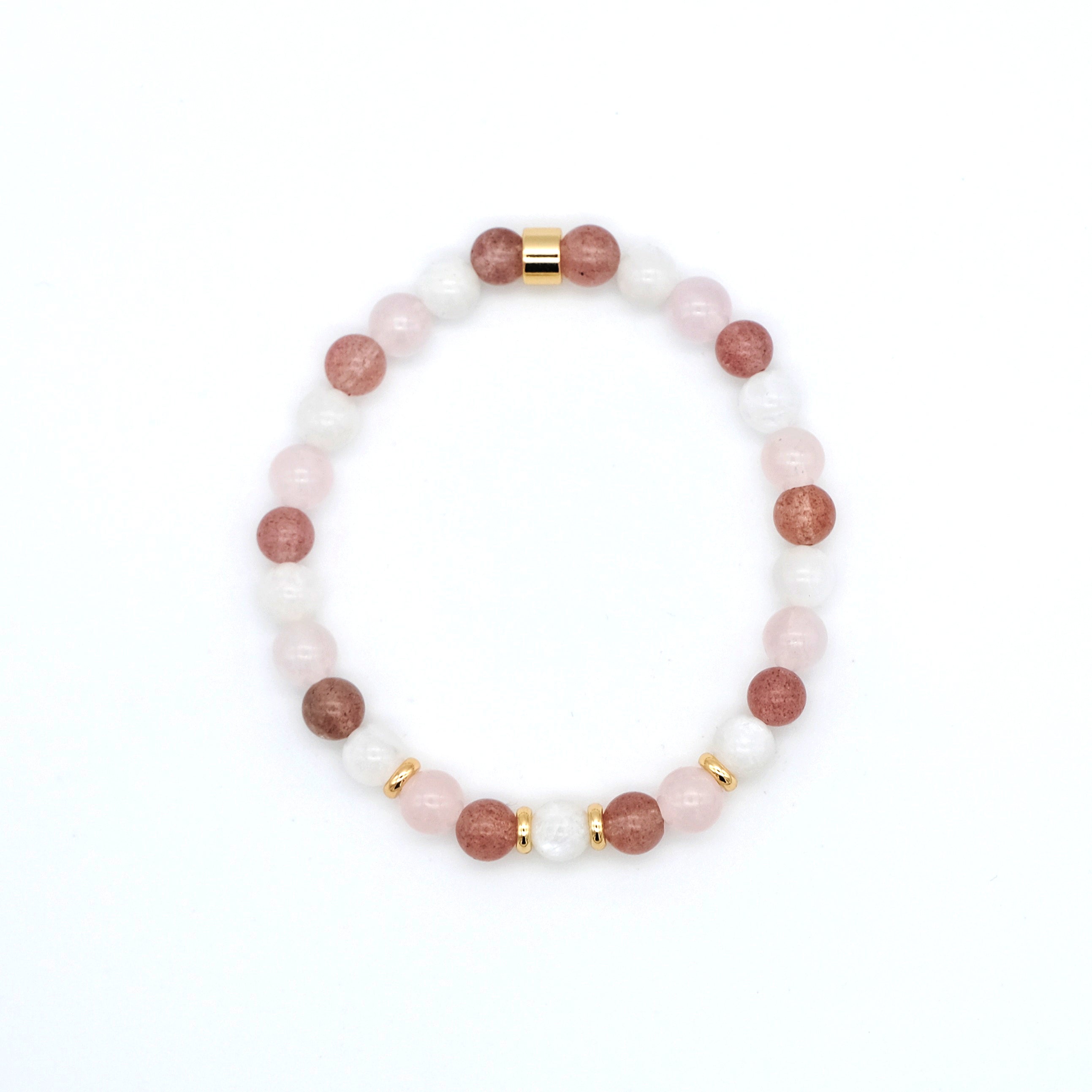 A moonstone, strawberry quartz and rose quartz gemstone bracelet in 6mm beads with gold accessories from above