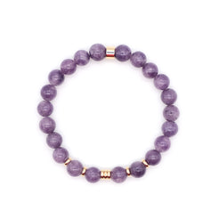 A lepidolite gemstone bracelet with gold accessories from above