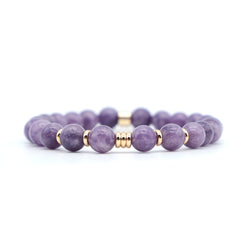 A lepidolite gemstone bracelet with gold accessories