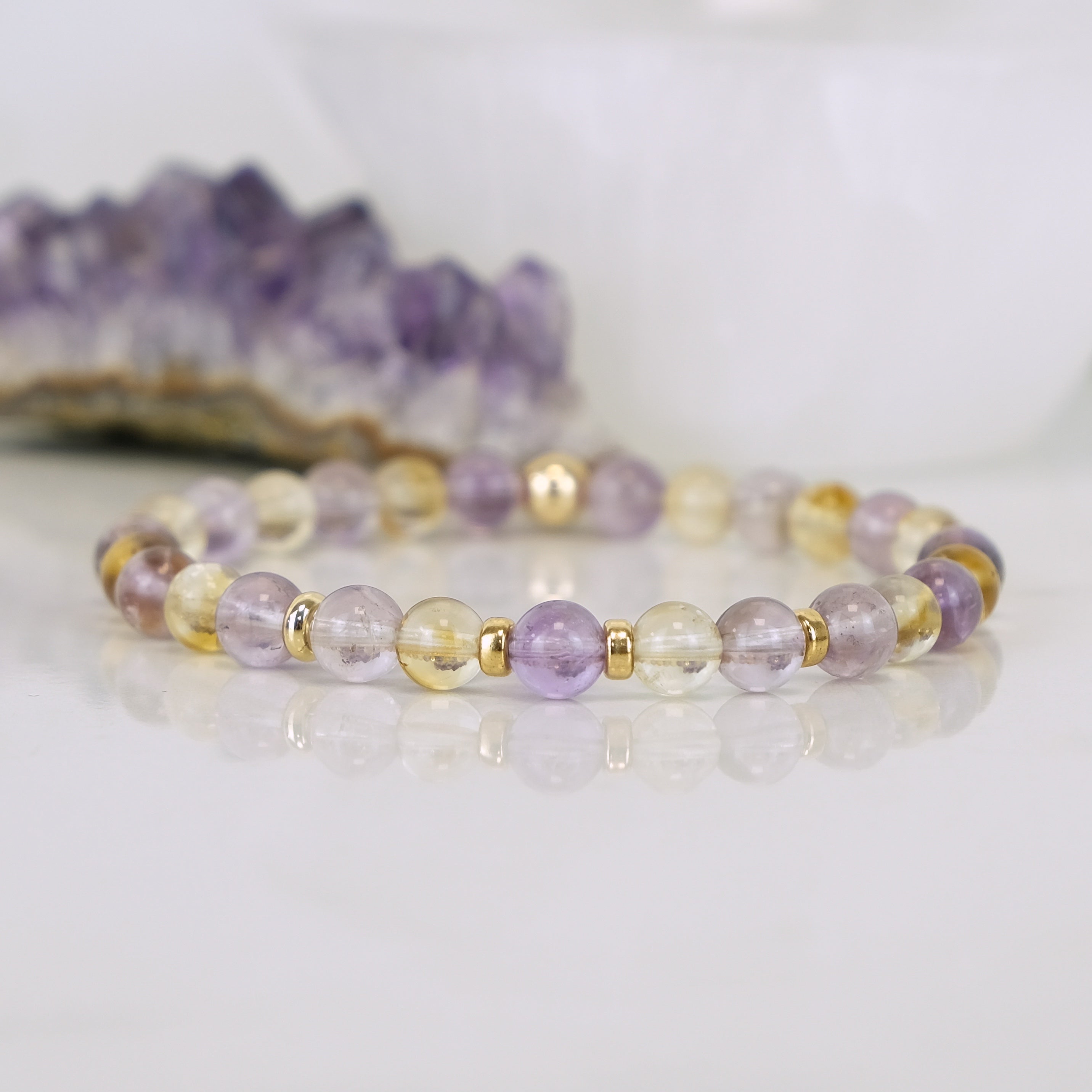 An Amethyst and citrine gemstone bracelet with gold filled accessories