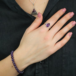 A model wearing an Amethyst teardrop gemstone ring in 925 sterling silver