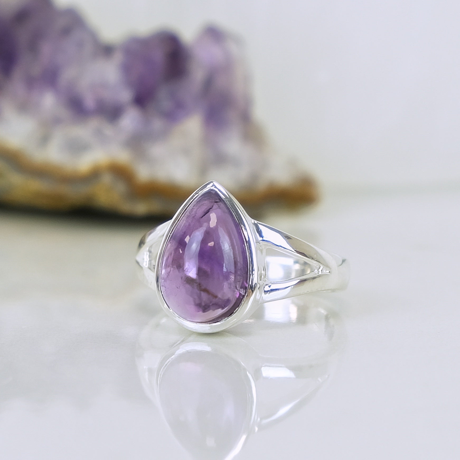 Amethyst teardrop gemstone ring in 925 sterling silver from a side angle