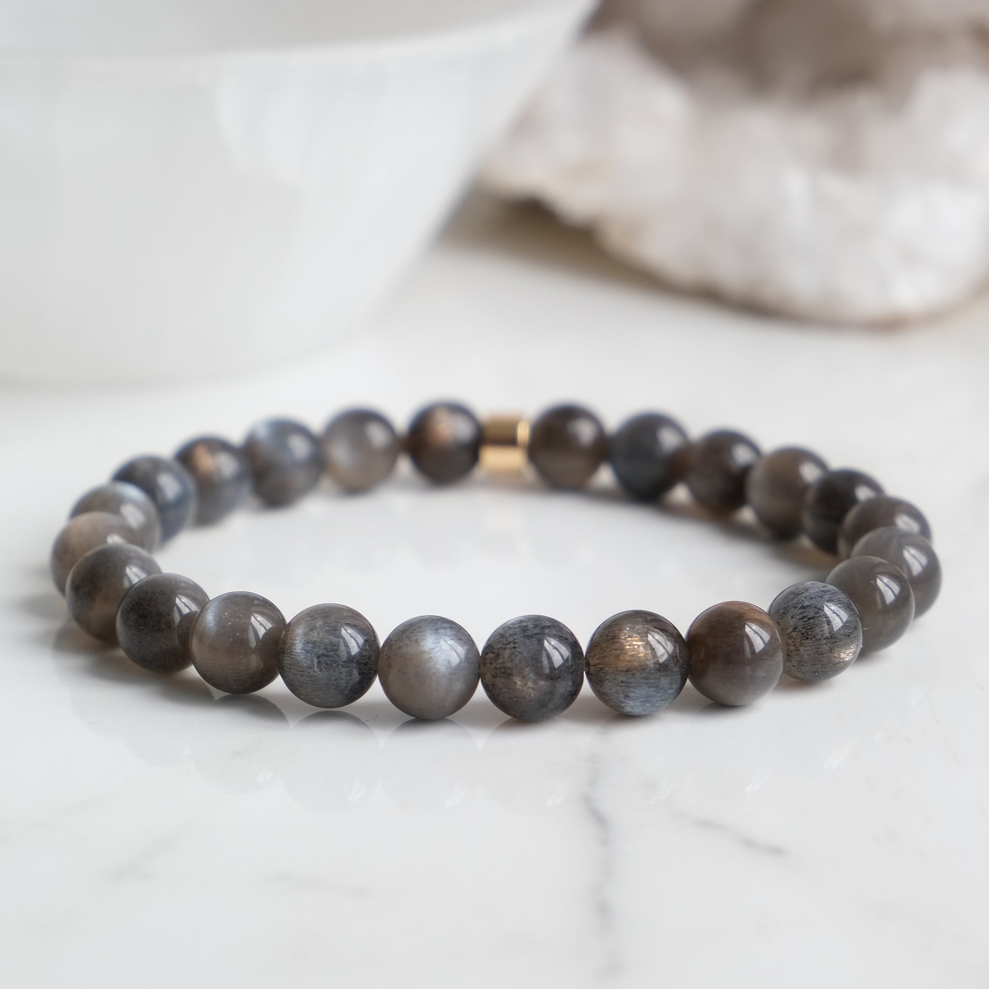 A black moonstone gemstone bracelet with gold feature bead