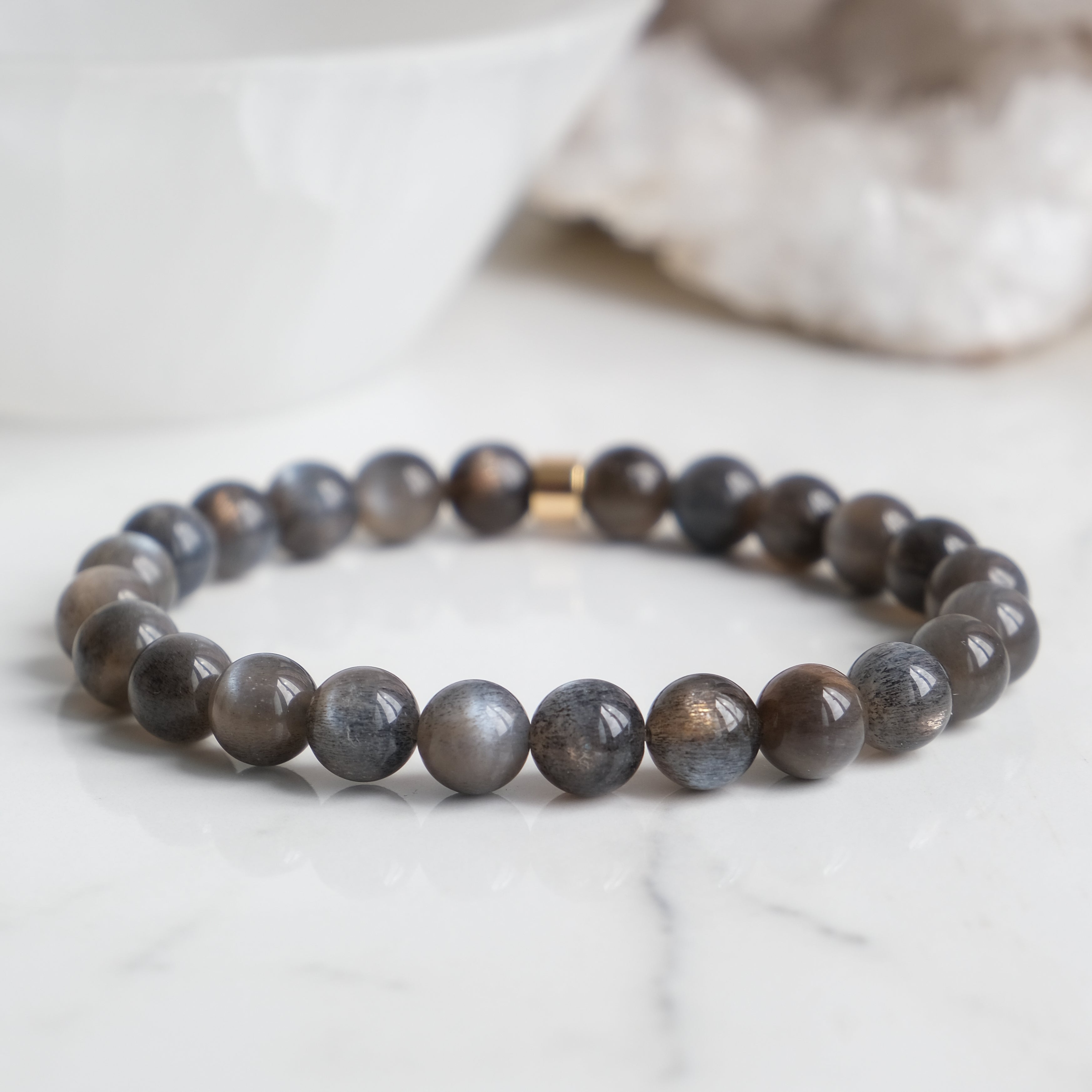 A black moonstone gemstone bracelet with gold feature bead