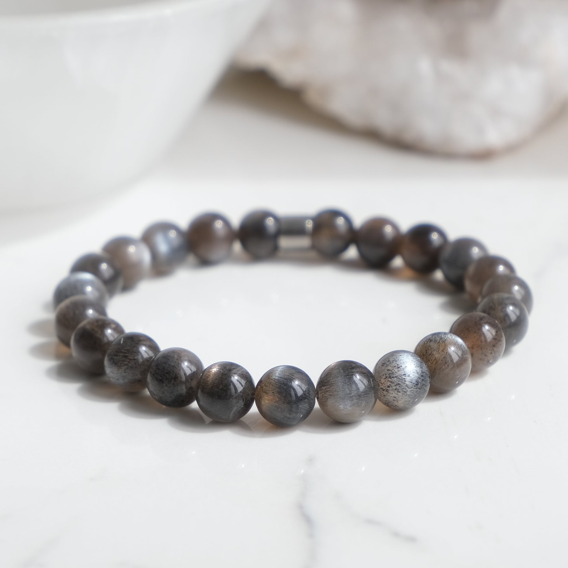 A black moonstone gemstone bracelet with steel feature bead
