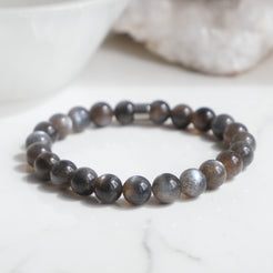A black moonstone gemstone bracelet with steel feature bead