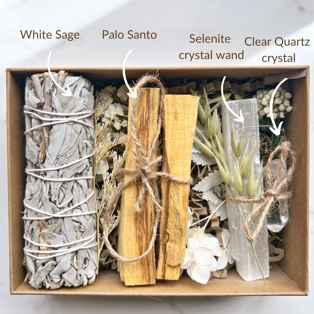 Cleansing kit boxed containing white sage, palo santo, selenite wand and clear quartz crystal