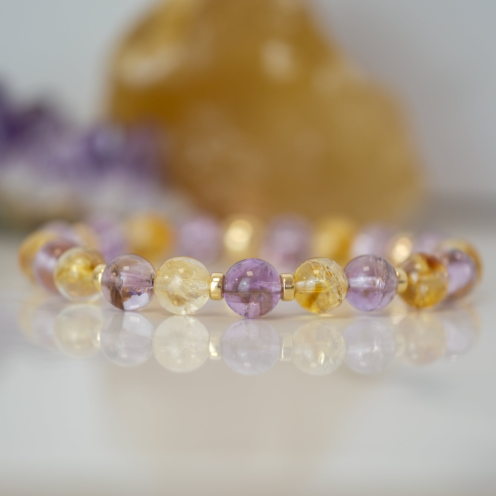 Close up photo of Amethyst and Citrine gemstone bracelet with 14kt gold filled accessories