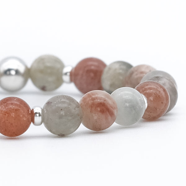 A close up of an Arusha sunstone gemstone bracelet with silver accessories