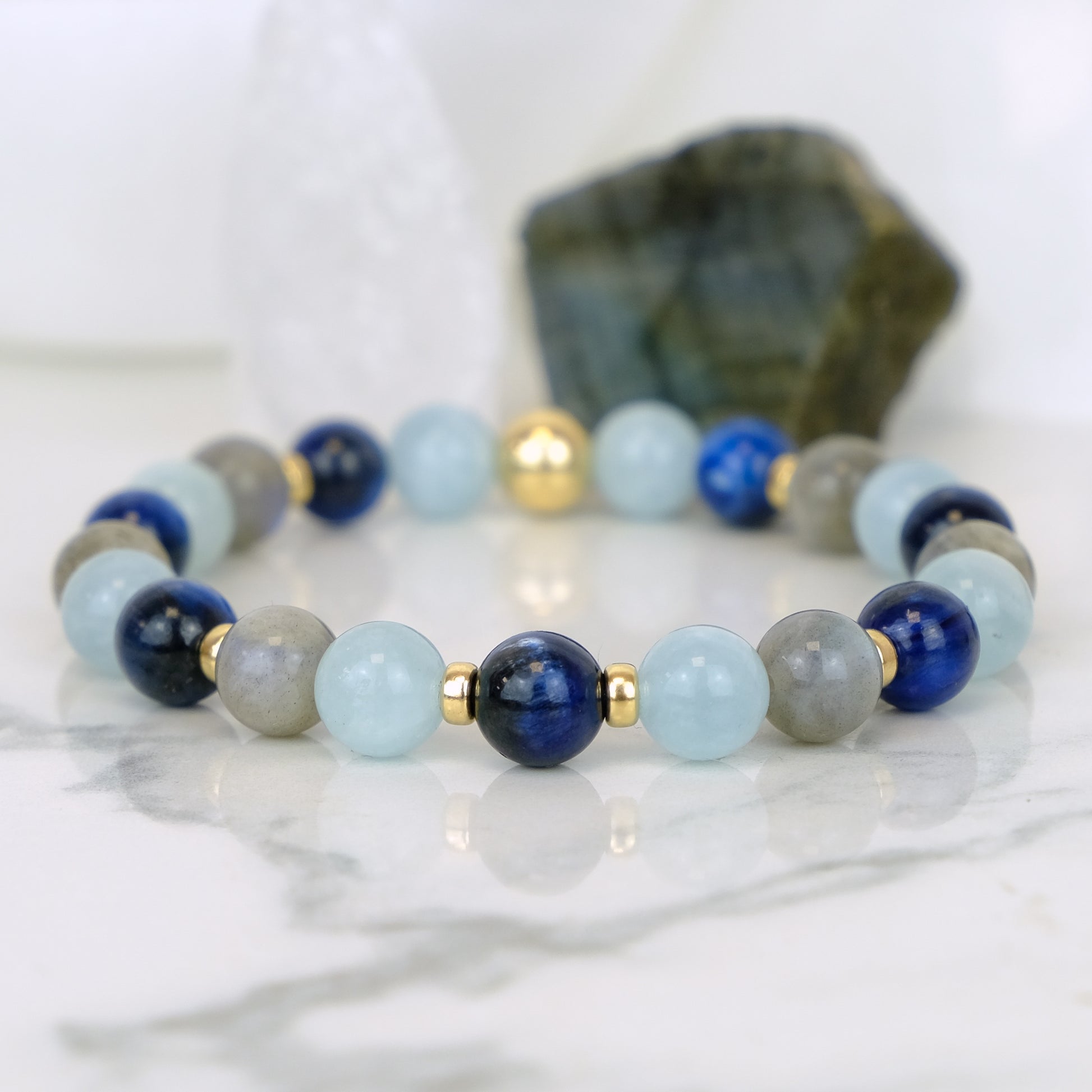 A Kyanite, Aquamarine and Labradorite gemstone bracelet with gold accessories 