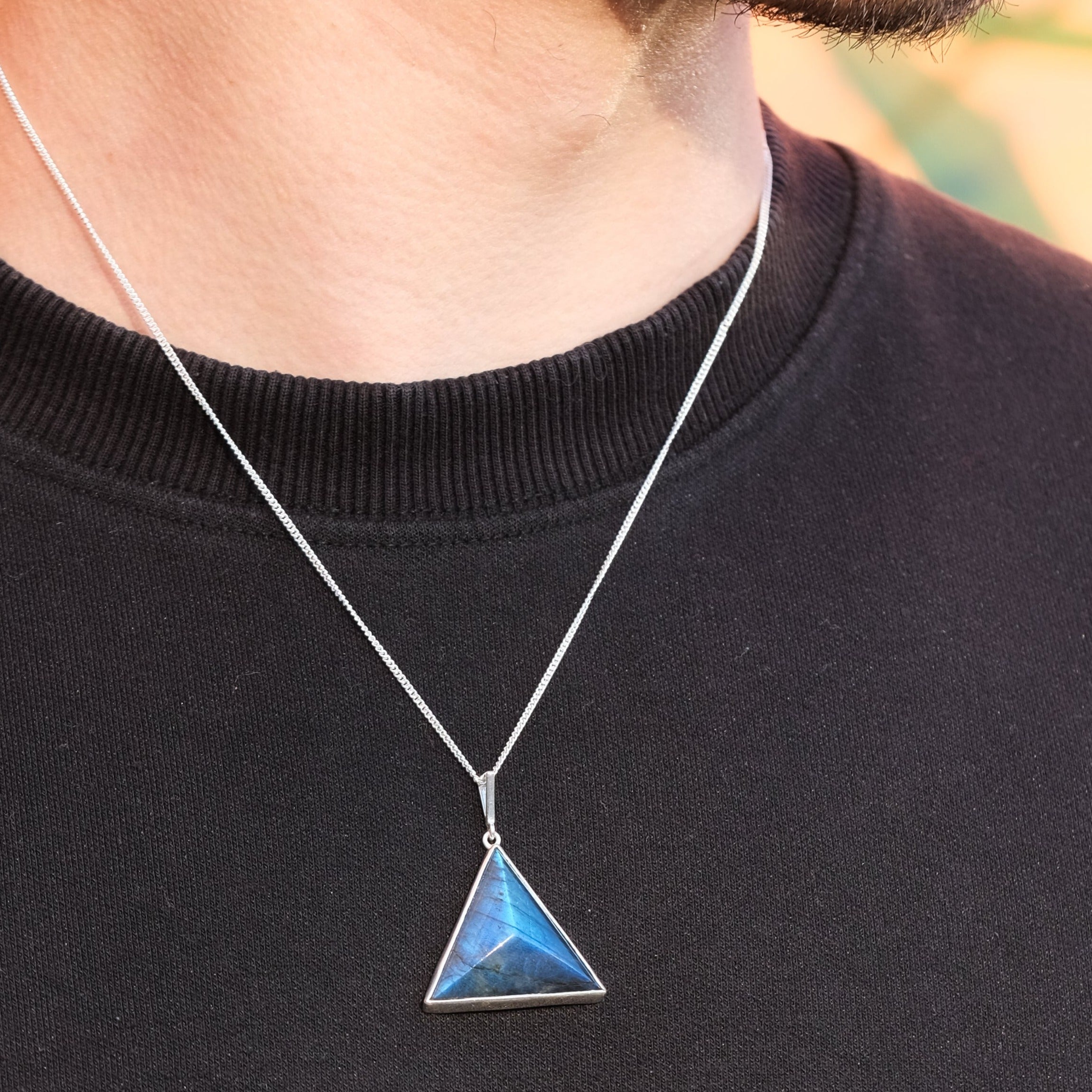 A model wearing a Labradorite triangle pendant necklace with 925 silver chain 