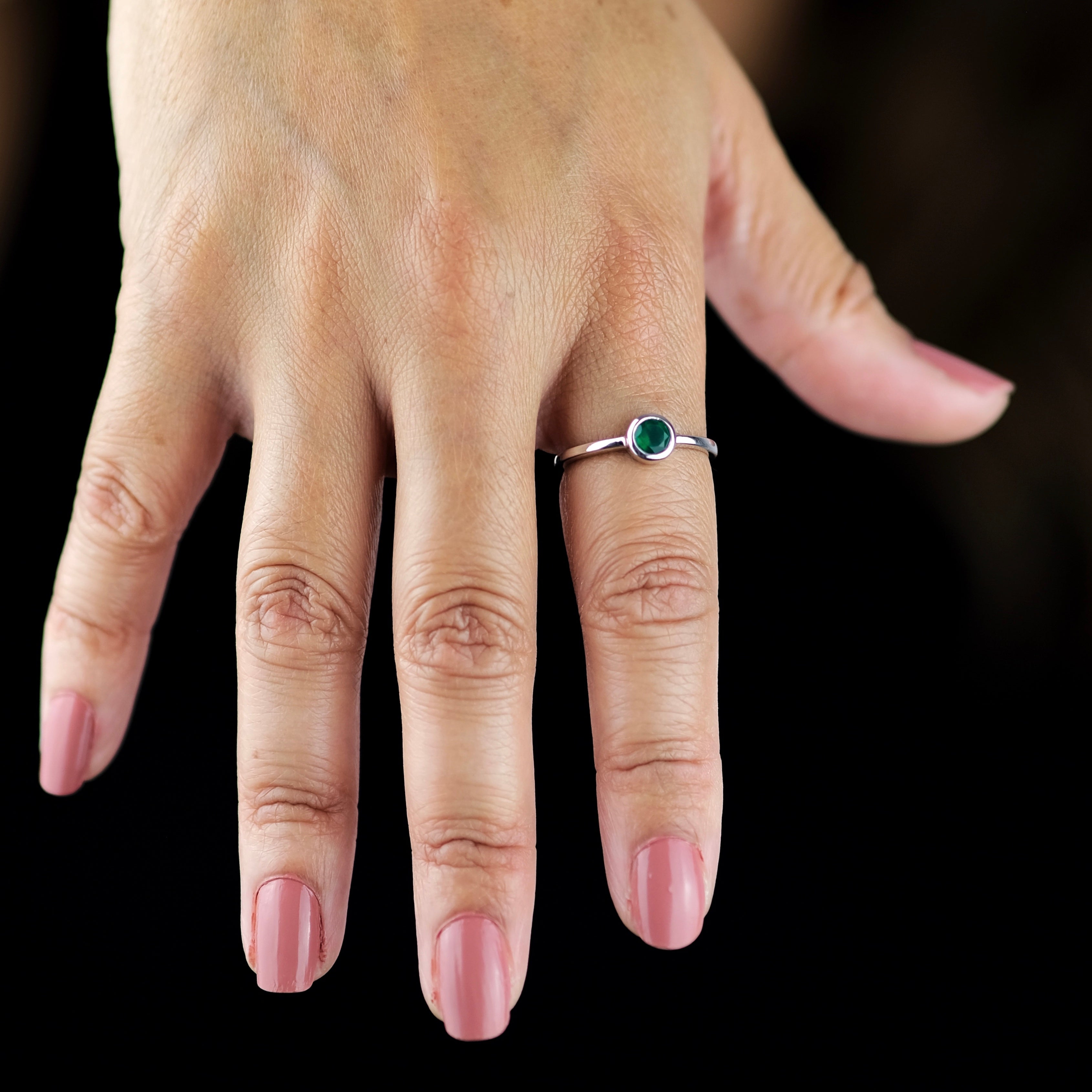 A model wearing Green onyx minimal circle gemstone ring in silver