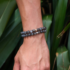 A model wearing two black moonstone gemstone bracelets