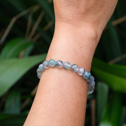 A moss agate gemstone bracelet worn by a model