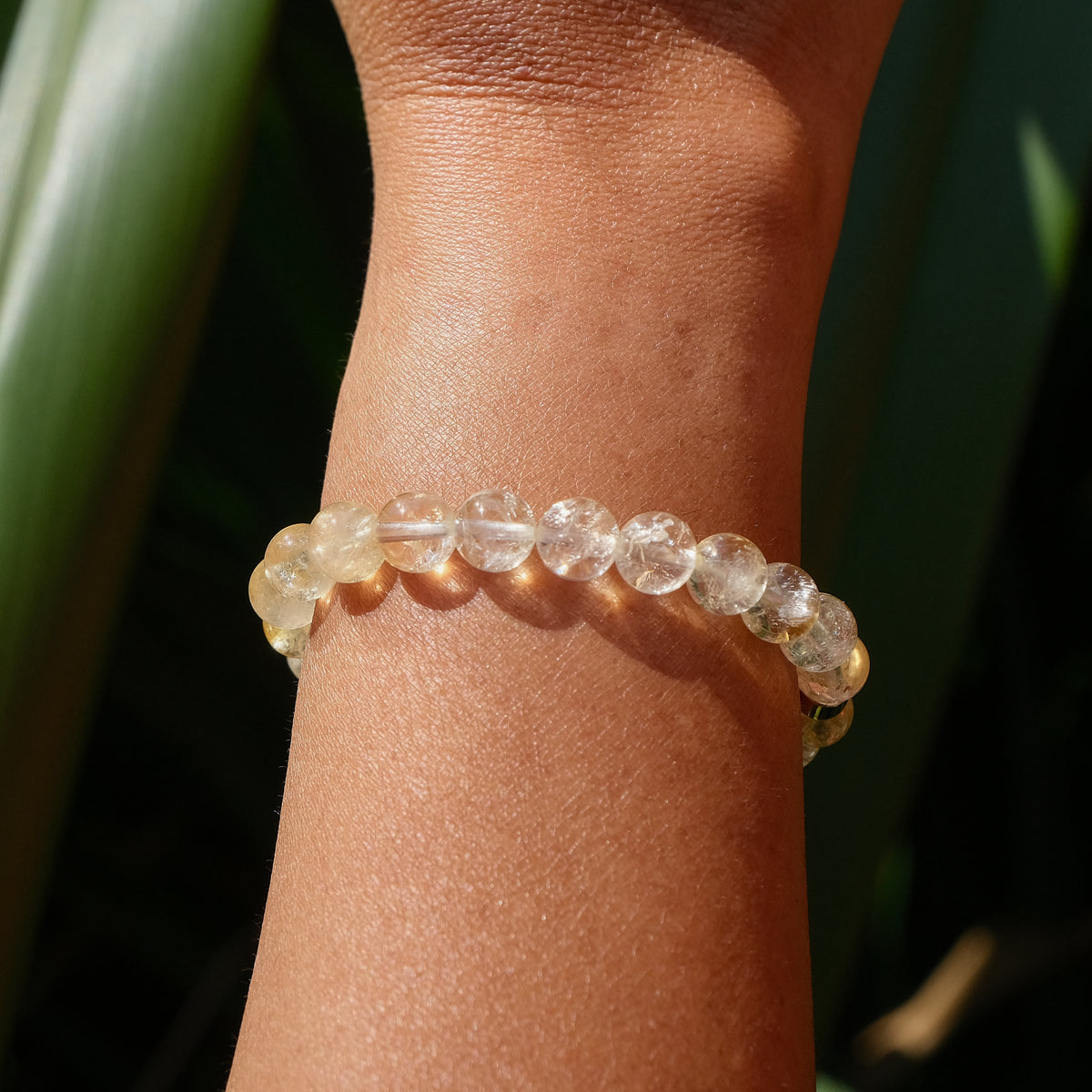 A citrine gemstone bracelet worn on a model's wrist