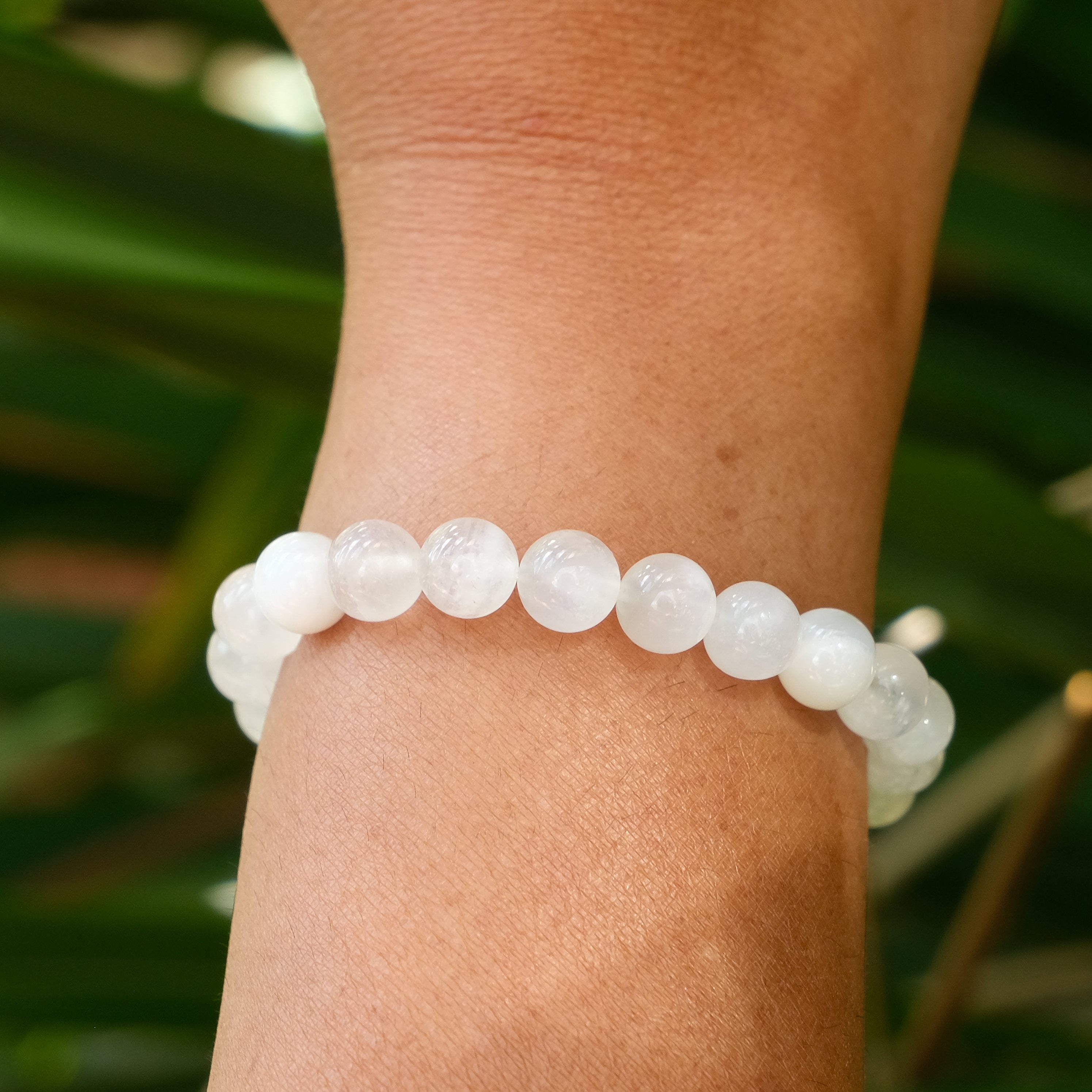 8mm moonstone gemstone bracelet worn on a model's wrist
