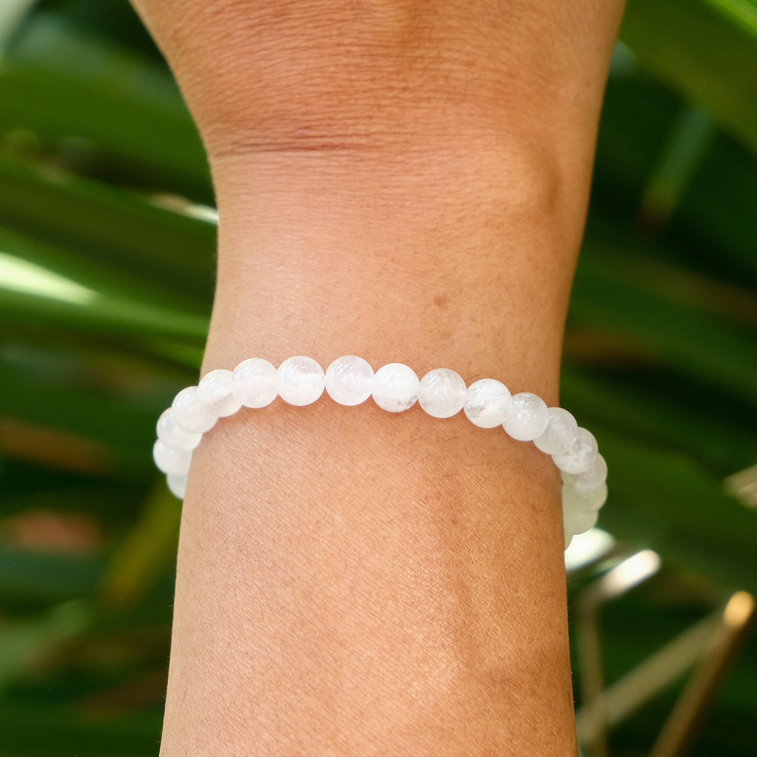 A 6mm moonstone bracelet on a model's wrist