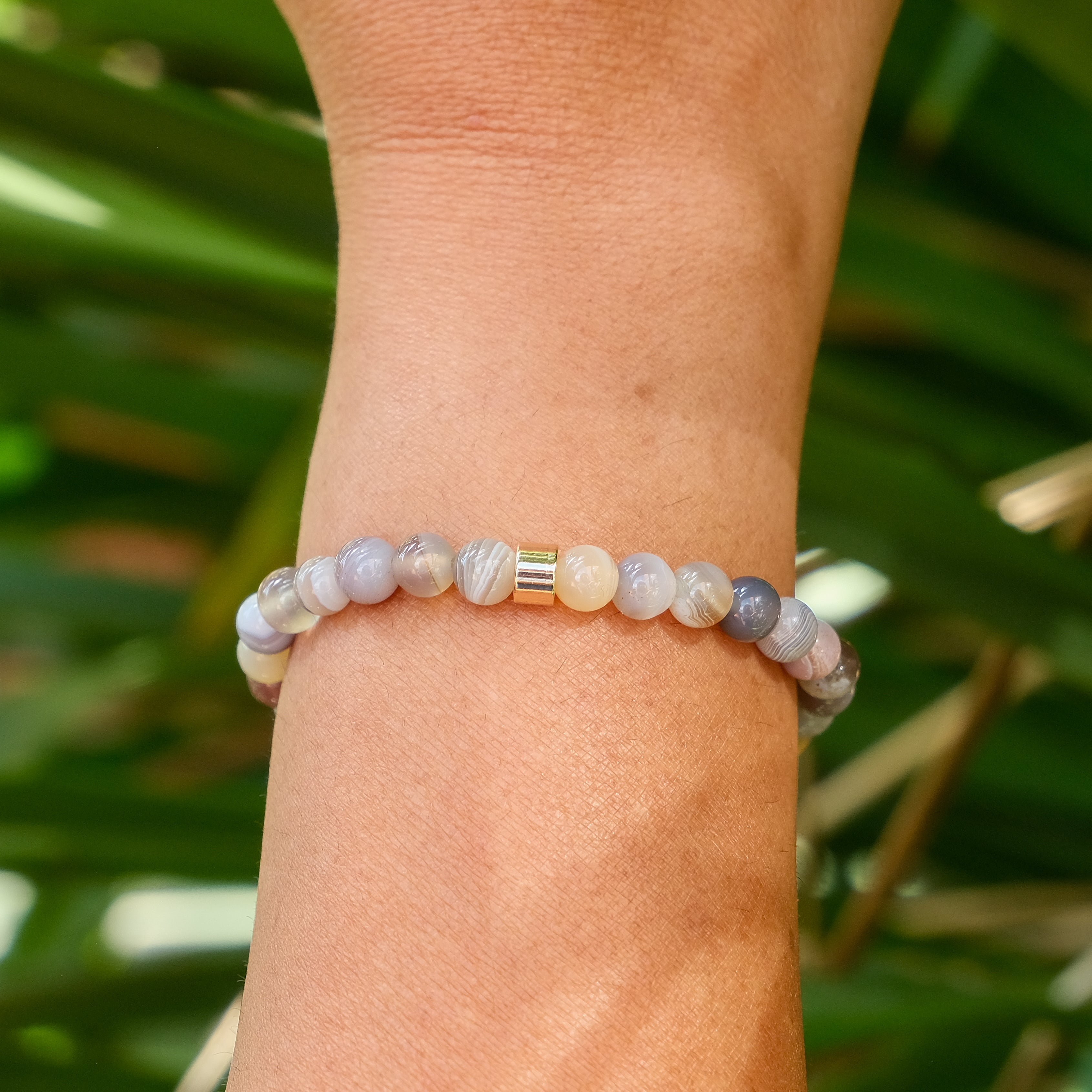 The back of a 6mm botswana agate gemstone bracelet worn on a model's wrist