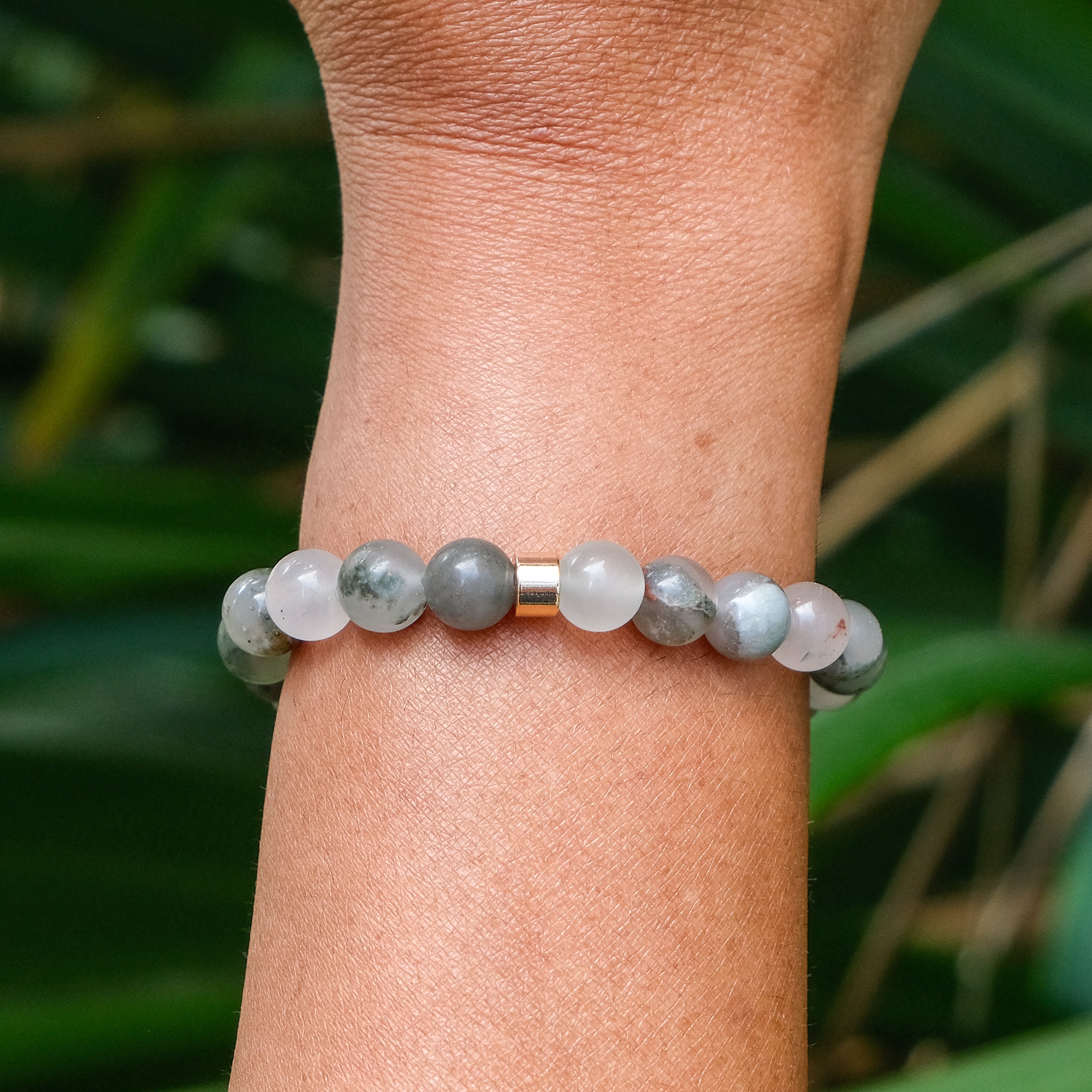 The back of A bloodstone gemstone bracelet worn on a model's wrist