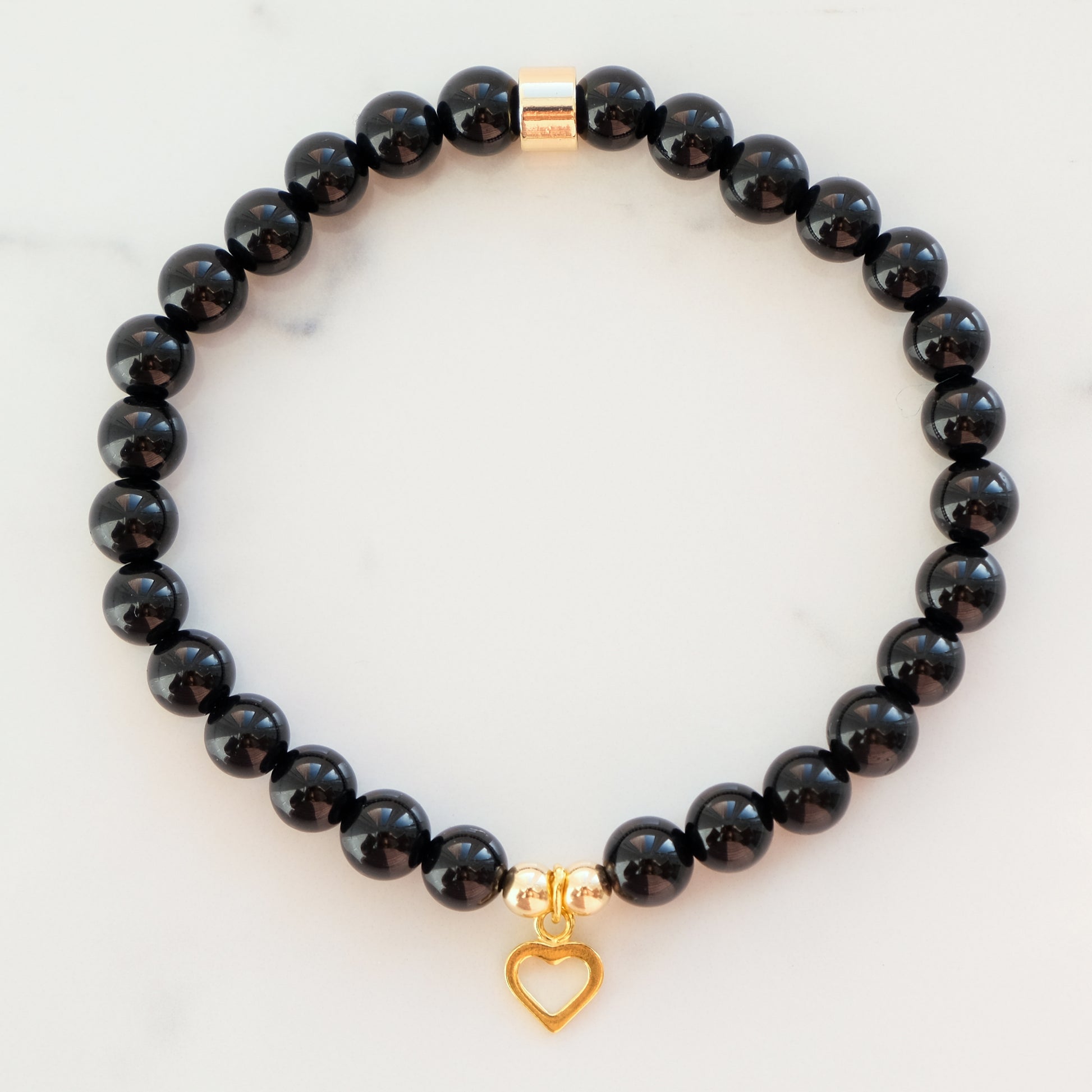 Black onyx gemstone bracelet in 6mm with gold heart charm