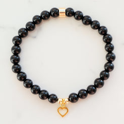 Black onyx gemstone bracelet in 6mm with gold heart charm
