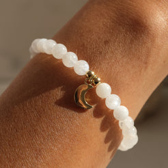 6mm moonstone gemstone bracelet with gold moon charm worn by a model