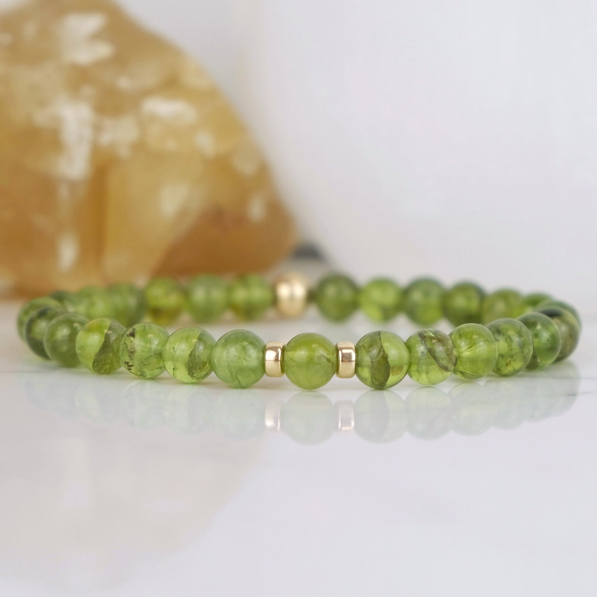A peridot gemstone bracelet with gold filled accessories