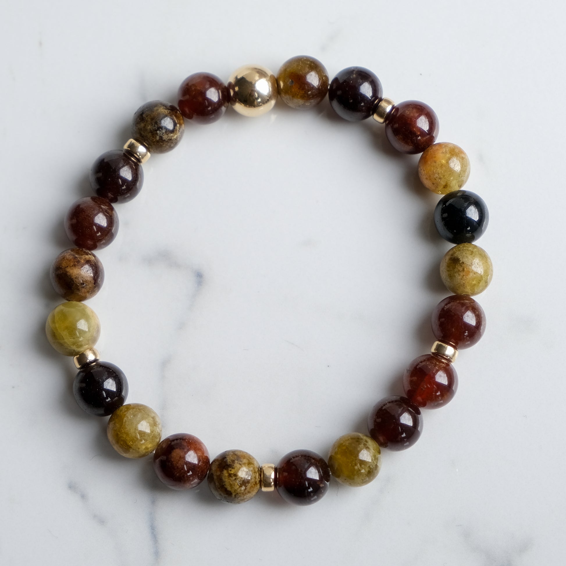 Garnet gemstone bracelet with gold accessories from above