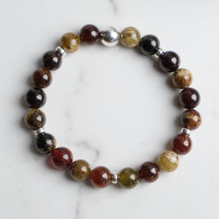 Garnet gemstone bracelet with gold accessories from above