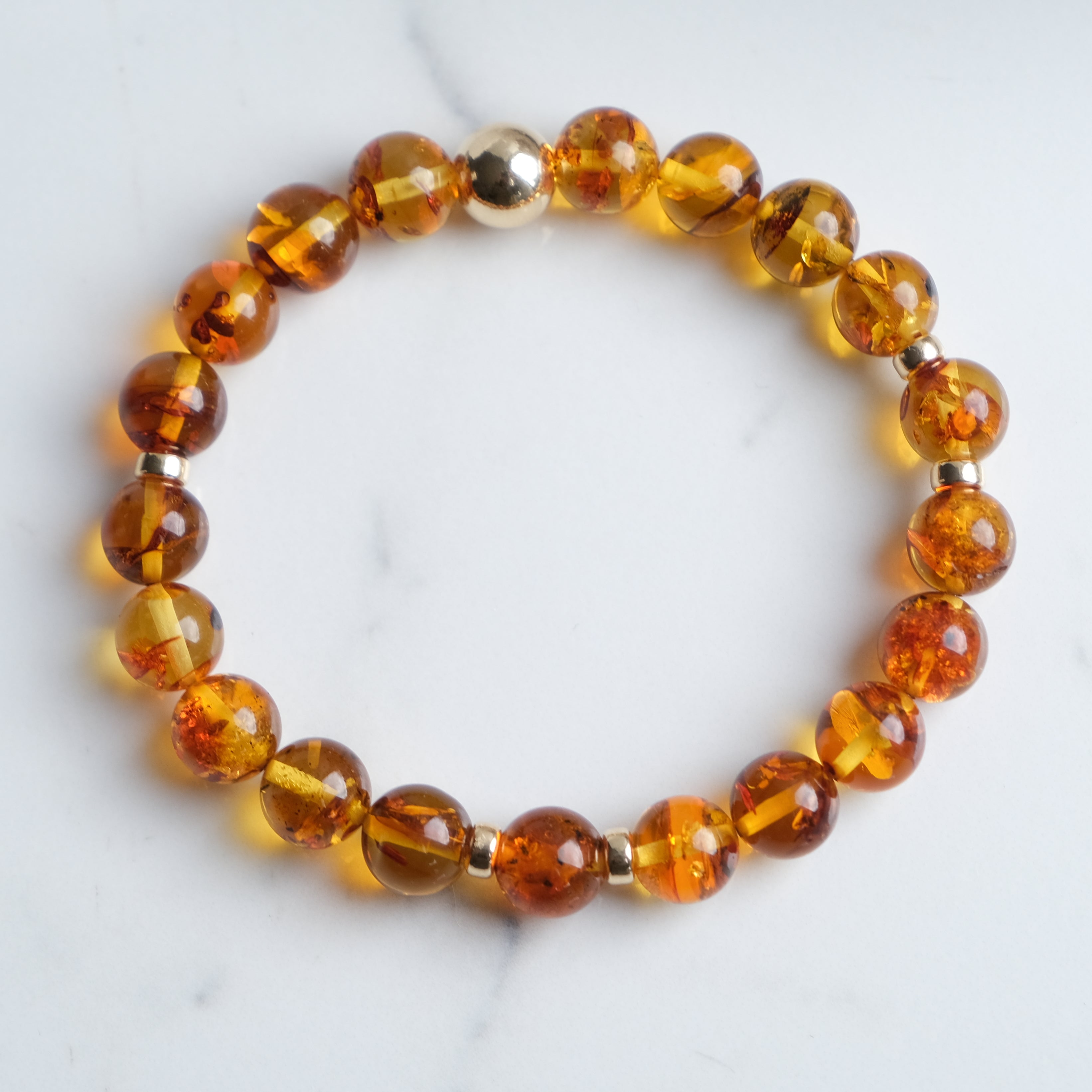Amber beaded bracelet with gold accessories from above