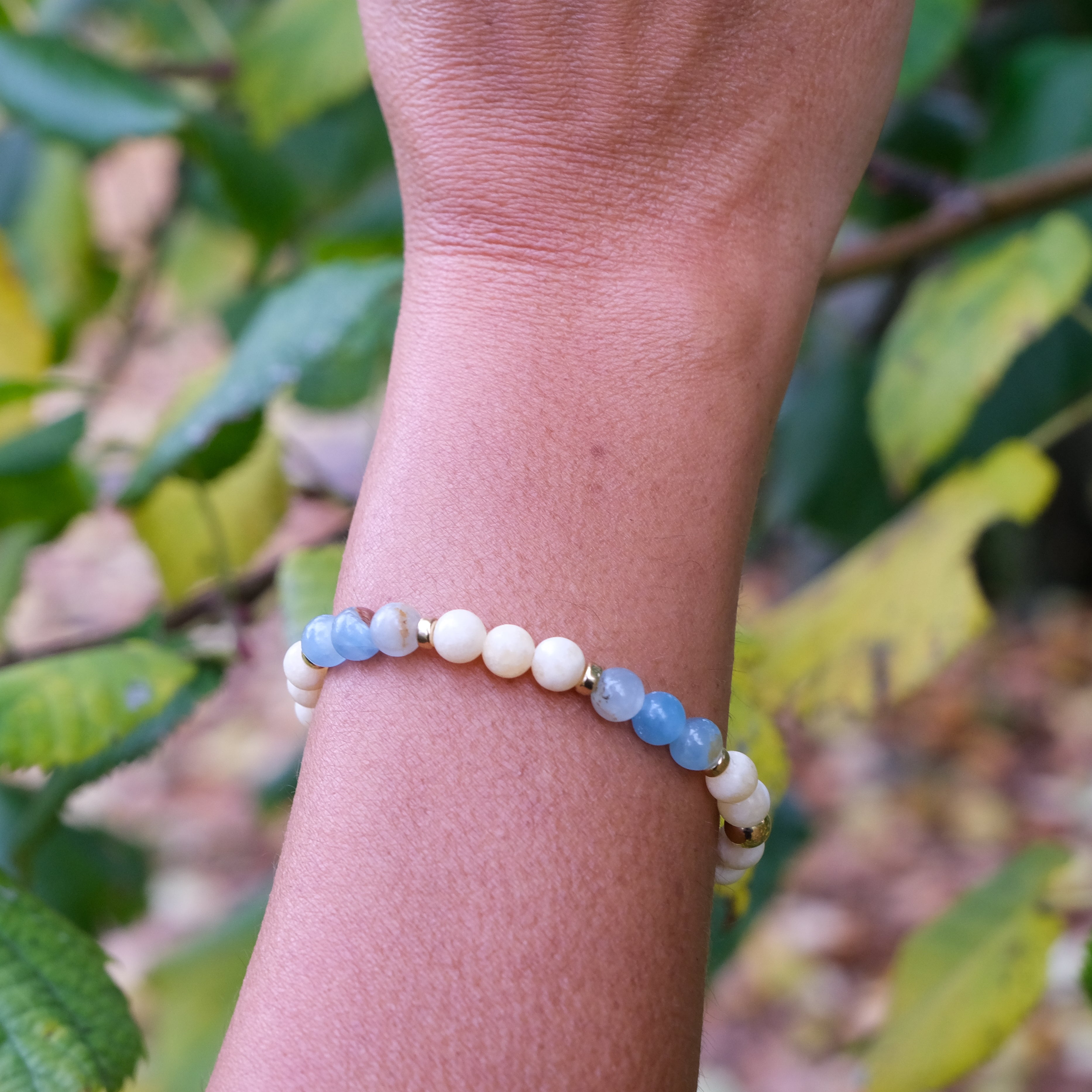 6mm yellow and blue calcite gemstone bracelet worn on a model's wrist