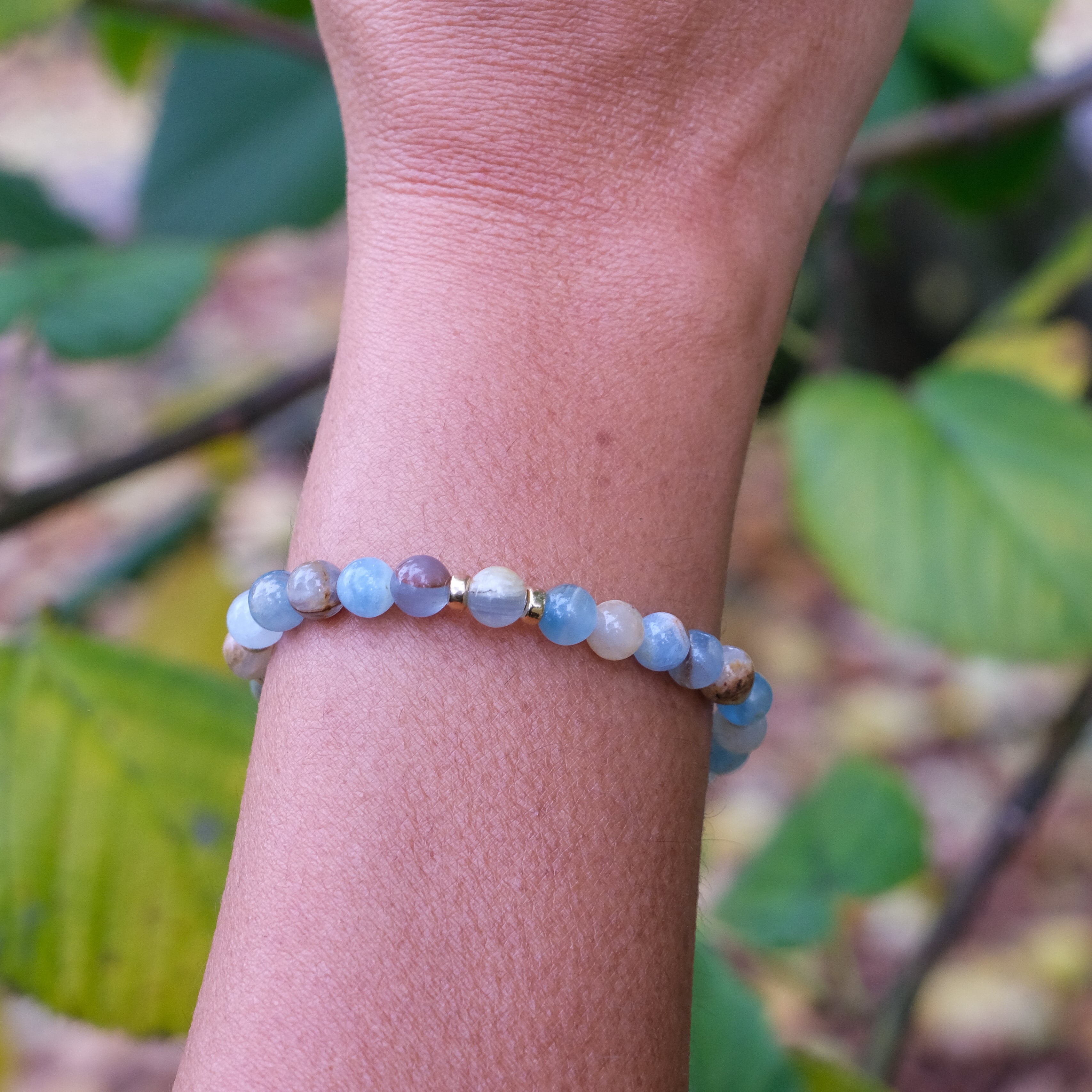 6mm blue calcite gemstone bracelet worn on a model's wrist