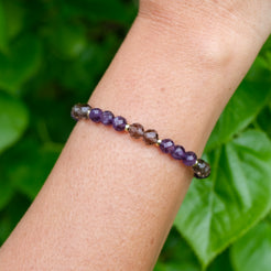 Amethyst and Ice Obsidian faceted crystal bracelet worn on the wrist