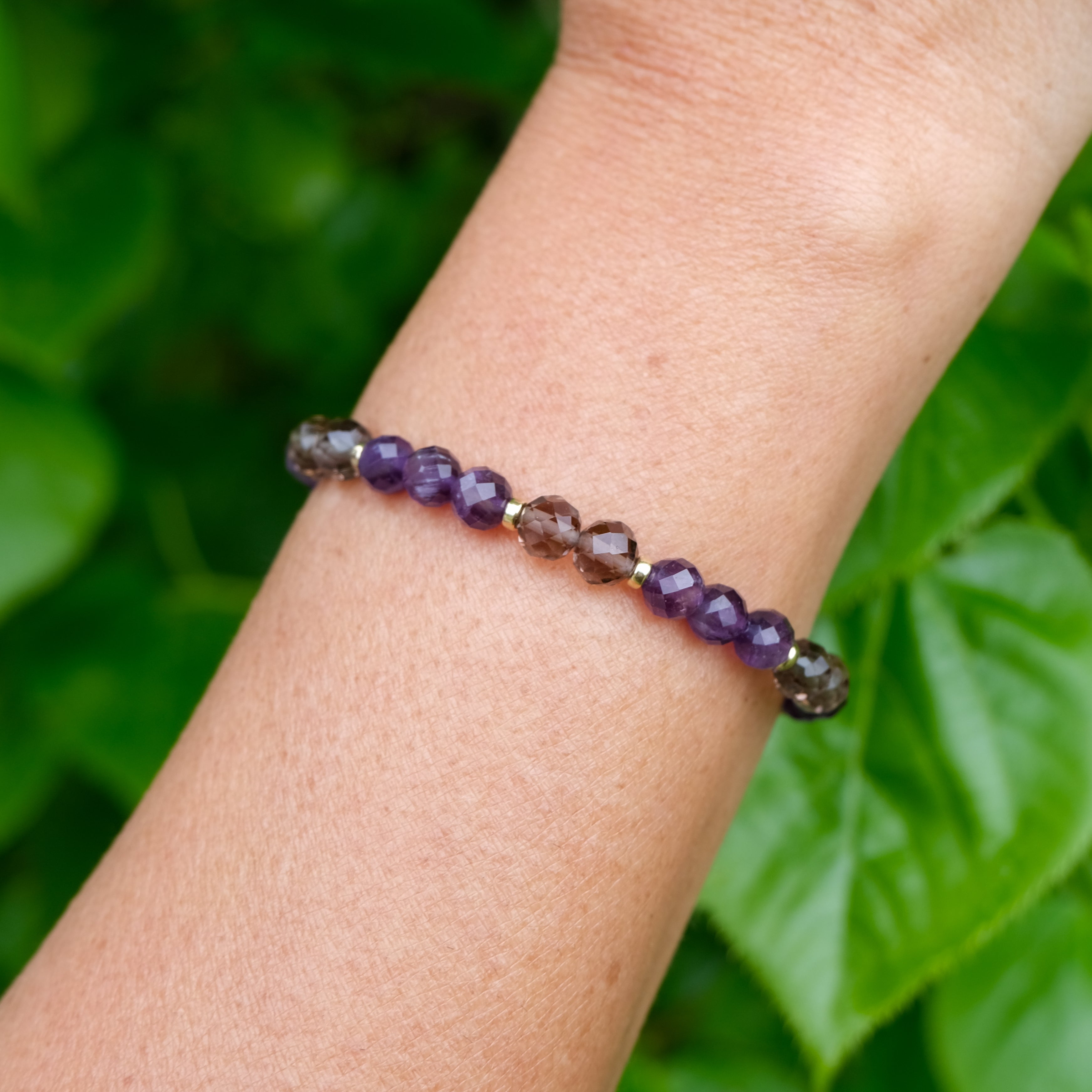 Amethyst and Ice Obsidian faceted crystal bracelet worn on the wrist