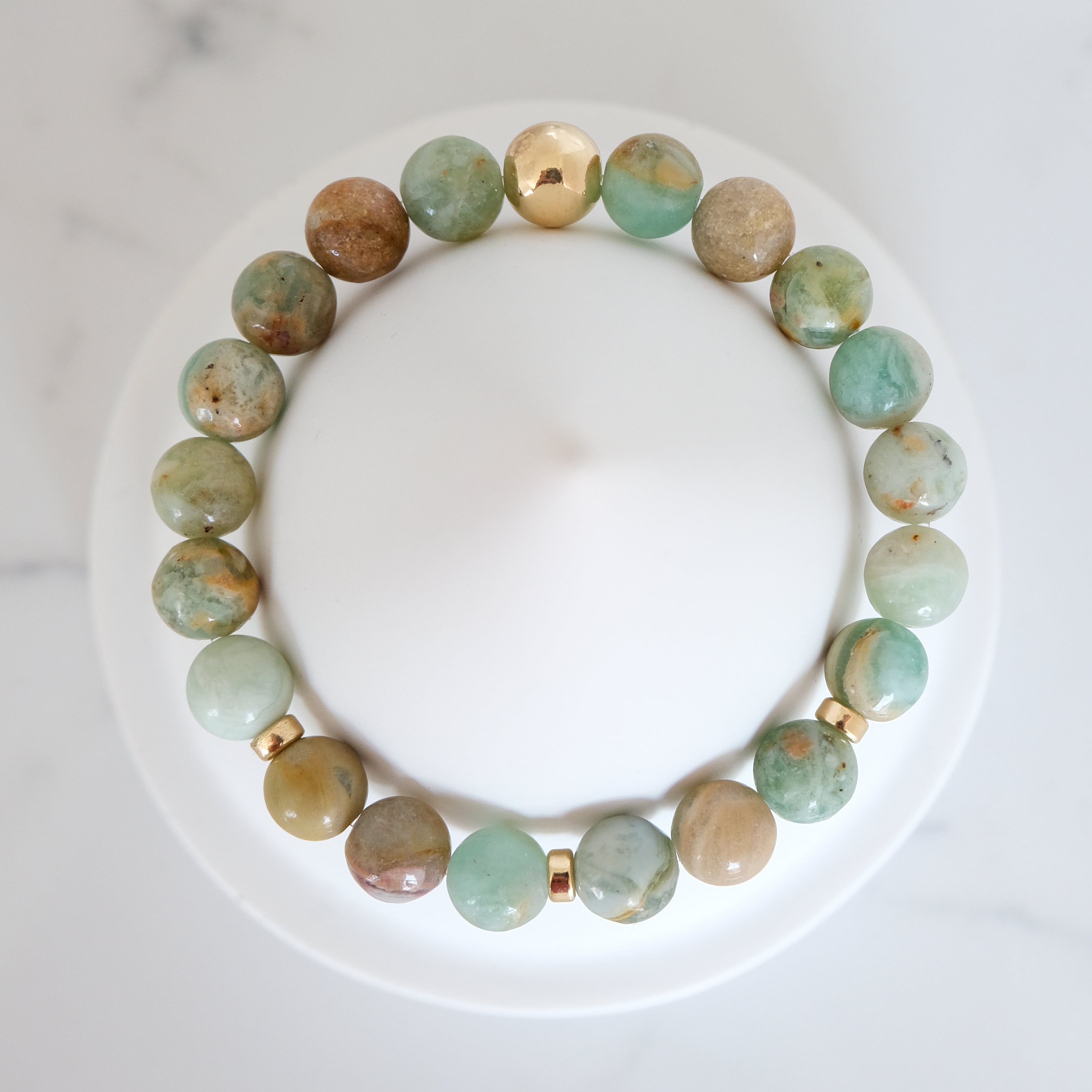 Green quartz gemstone bracelet with gold accessories from above
