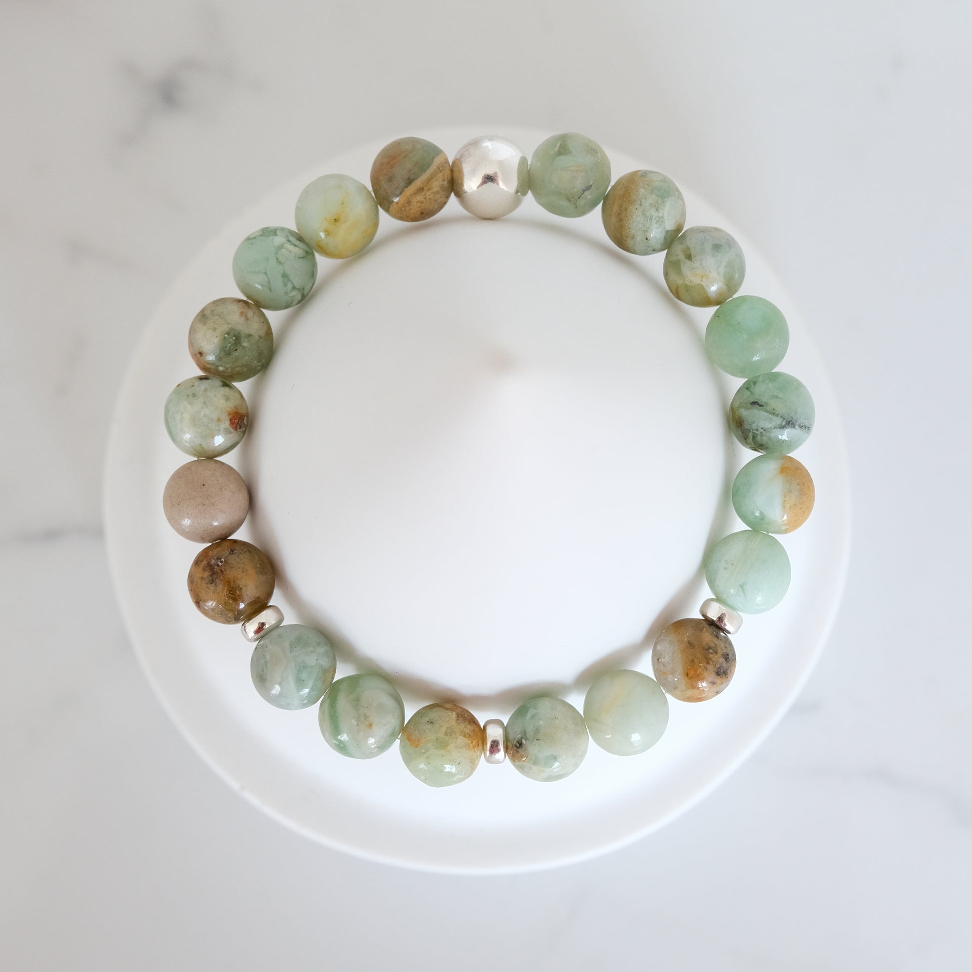 Green quartz gemstone bracelet with silver accessories from above
