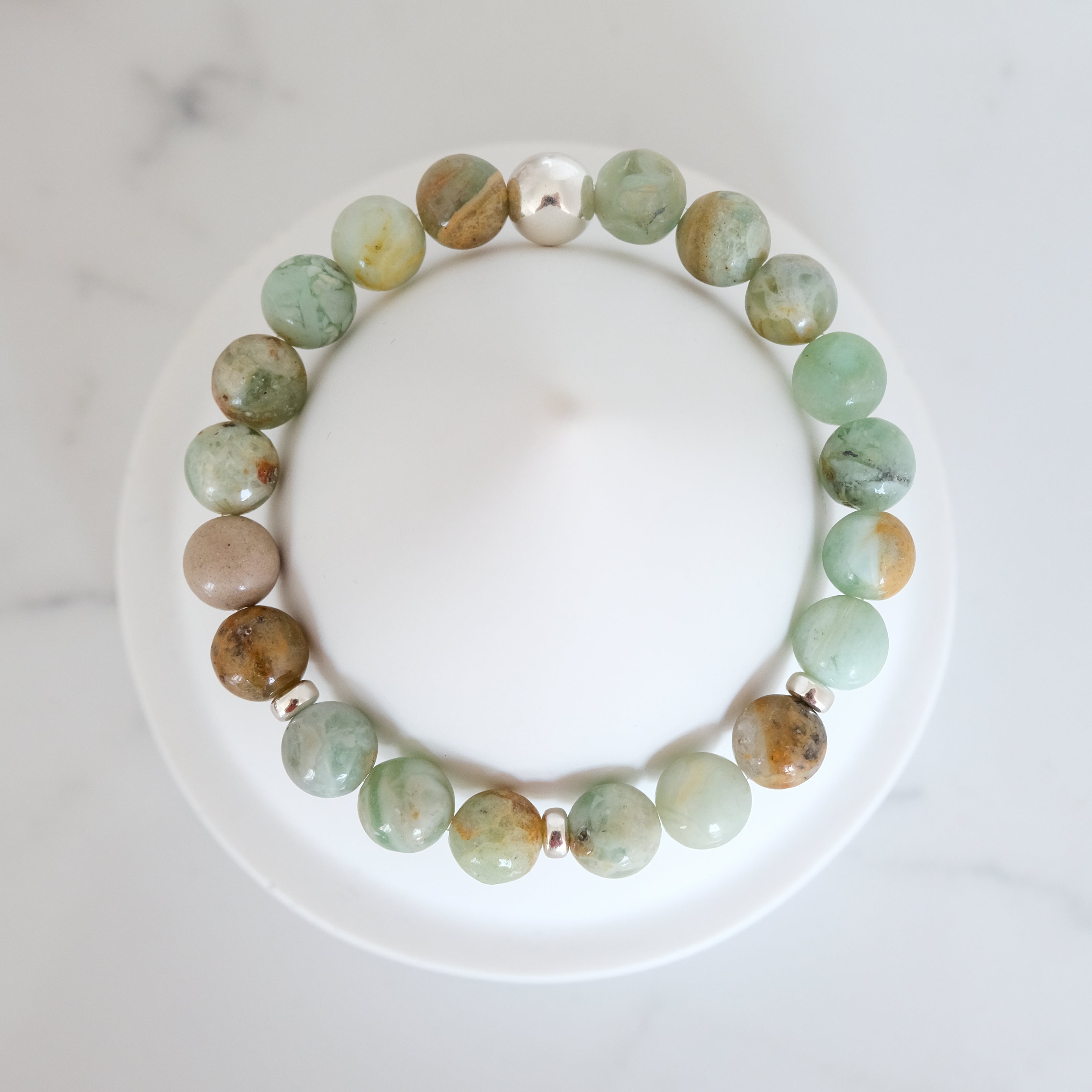 Green quartz gemstone bracelet with silver accessories from above