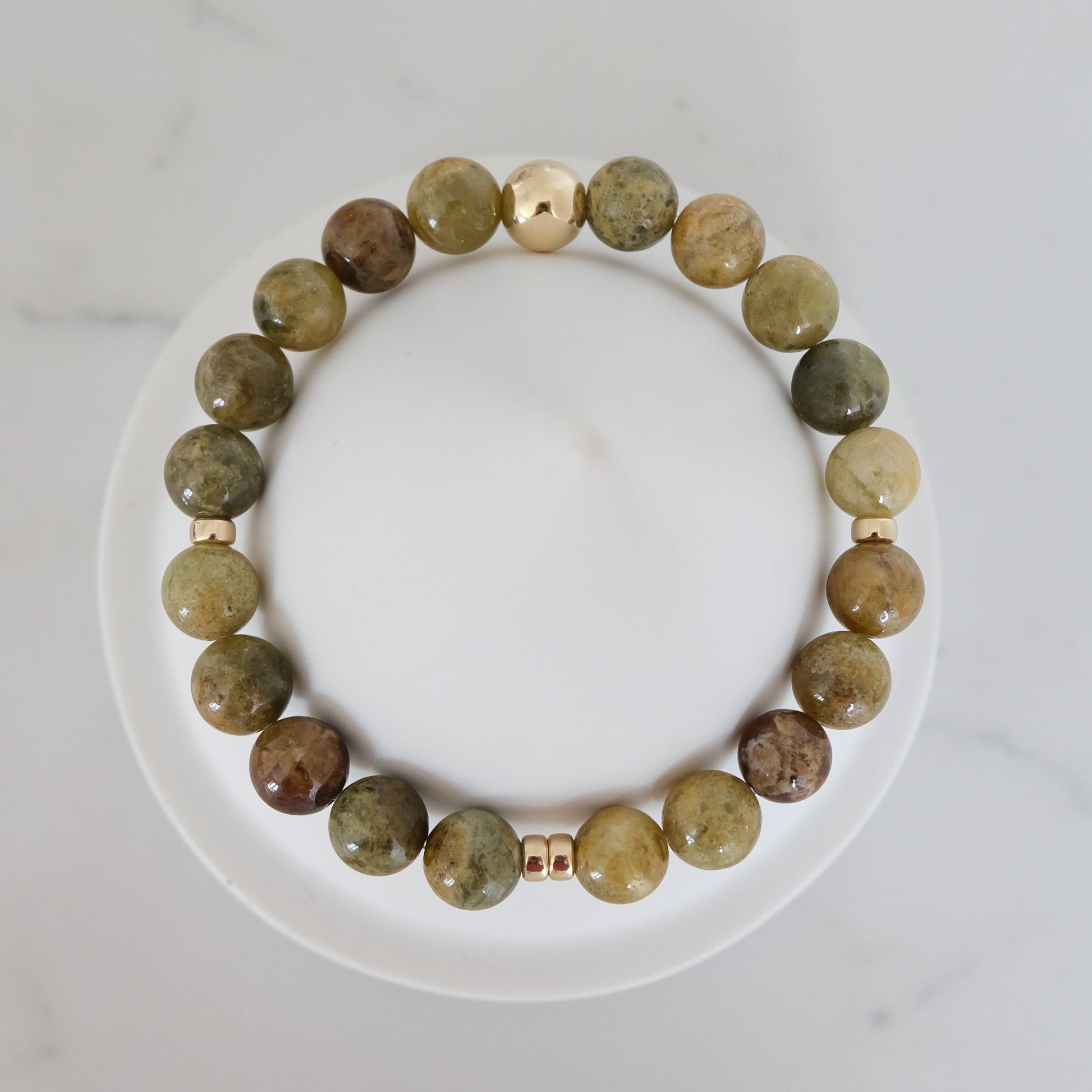 Green garnet gemstone bracelet in 8mm with gold accessories from above