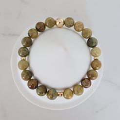Green garnet gemstone bracelet in 8mm with gold accessories from above