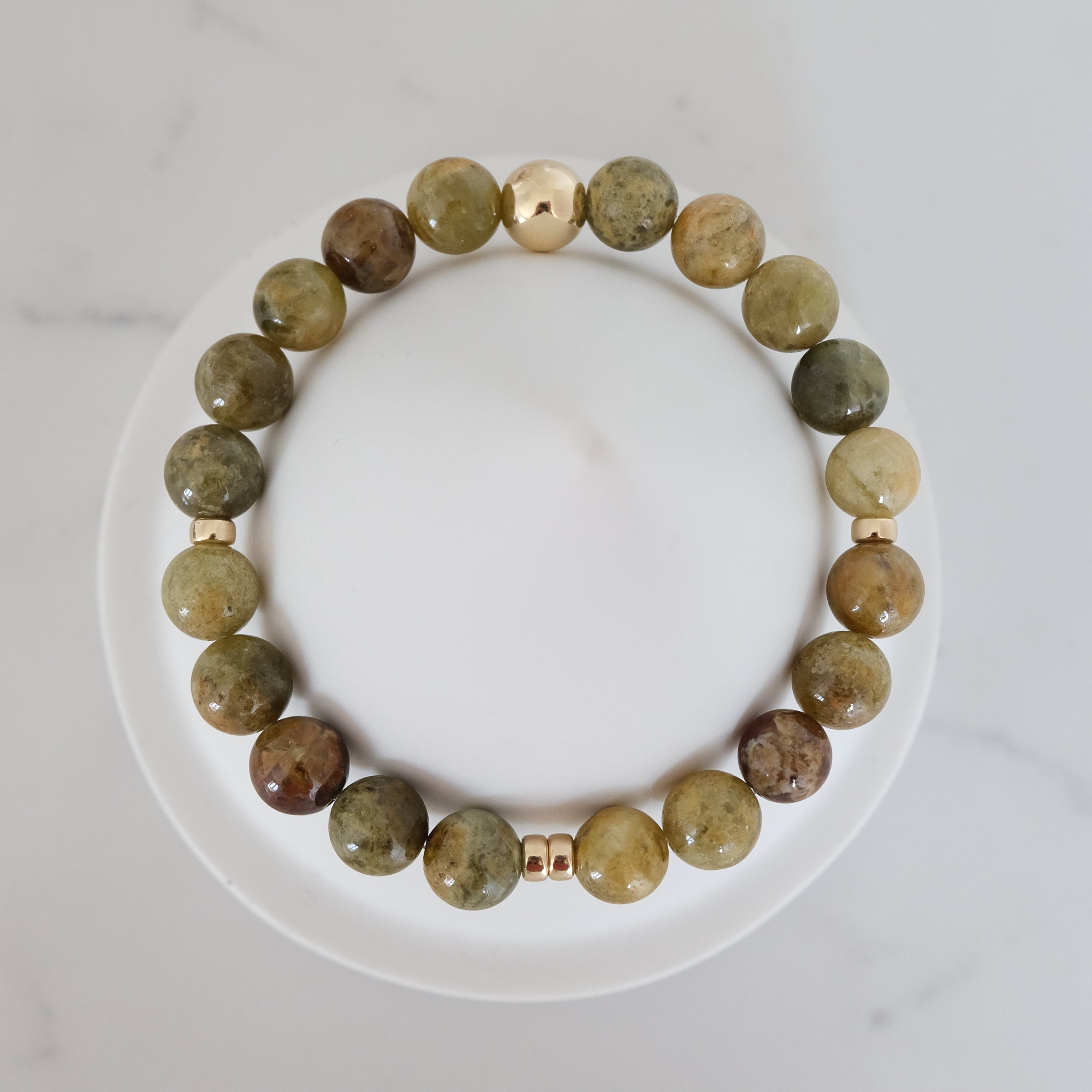 Green garnet gemstone bracelet in 8mm with gold accessories from above