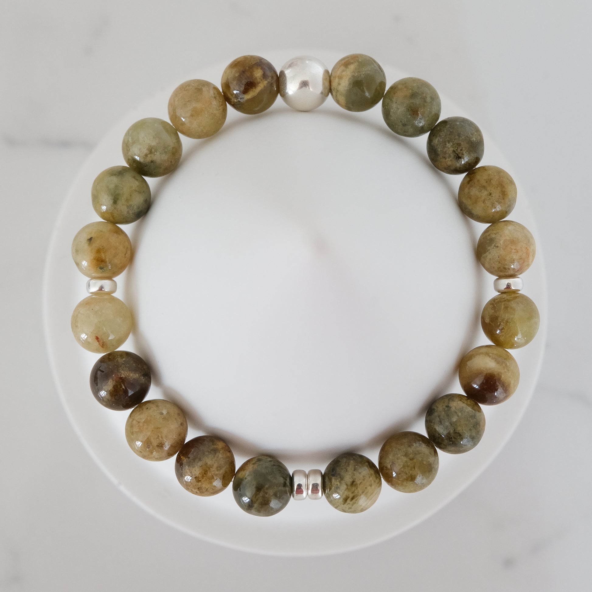Green garnet gemstone bracelet in 8mm with silver accessories from above
