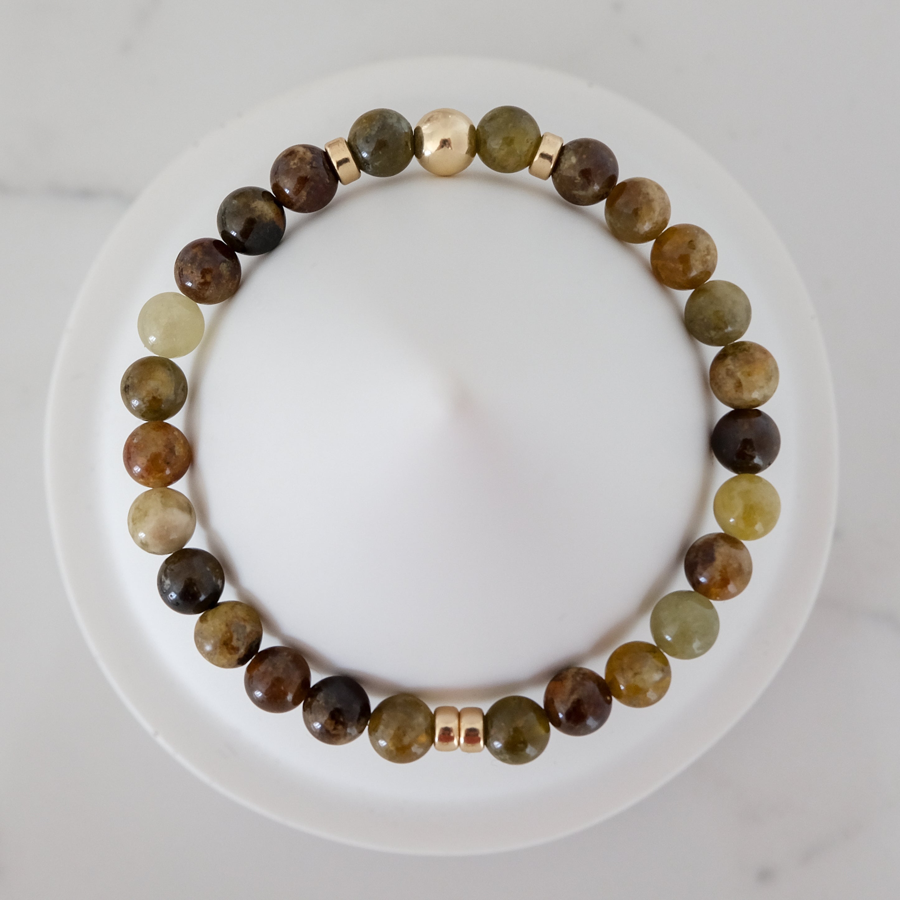 Green garnet gemstone bracelet in 6mm with gold accessories from above